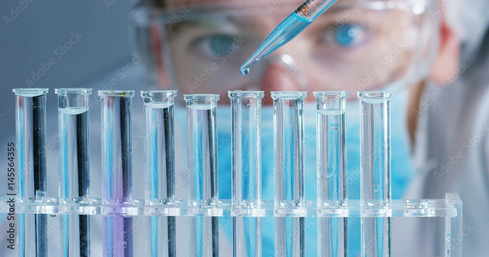 Wall mural close up of a scientist with futuristic graphics with which scans and reads the dna. concept: immers