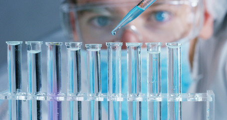 Close up of a scientist with futuristic graphics with which scans and reads the DNA. Concept: immersive technology, augmented reality, science and research.	