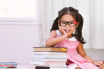 Portrait of happy asian little girl with book