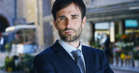 Fototapeta premium A man in a suit, looks in camera and smiles proud and sure of himself. Concept of politics, business, finance, banking, insurance and testimonials for political campaign. 