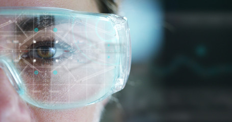 A woman watches with a futuristic look with glasses. augmented reality in holography.	