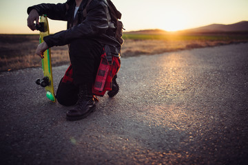 Fototapeta na wymiar Man relaxing on the street with skateboard