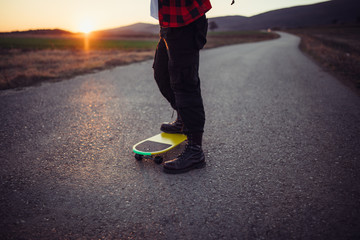 Cropped photo of a man's legs on a skateboard