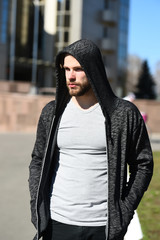 man sport fashion, bearded guy model in black hoodie