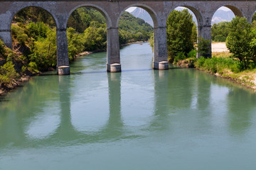 Fototapeta premium Bridge and river in the alps