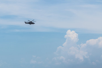 Flying helicopters in blue sky.