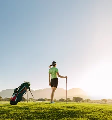 Tableaux ronds sur aluminium brossé Golf Woman golfer playing on golf course on a summer day