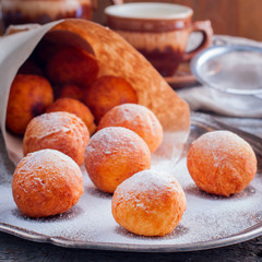 Donuts of cottage cheese in a paper bundle, square