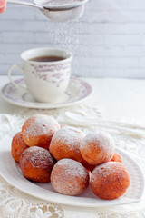 Freshly baked cheese donuts with powdered sugar, selective focus