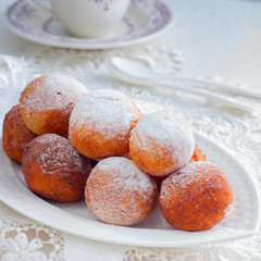 Freshly baked cheese donuts with powdered sugar, selective focus