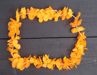 Dutch orange flower necklace on wooden background