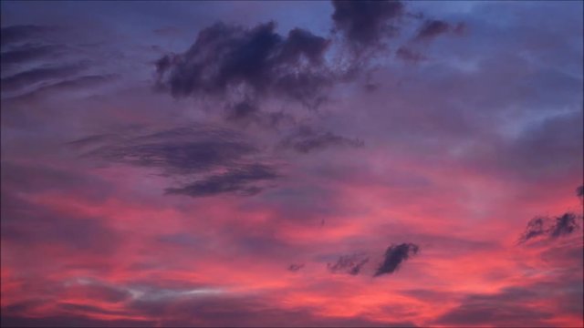 Clouds with orange, purple and black colors at sunset sky. 