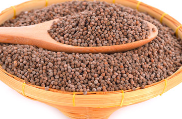 Organic natural sesame seeds on wooden spoon (Perilla frutescens