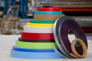 Multicolored bobbins of PVC edge and melanin for the manufacture of furniture. Lie pyramid.