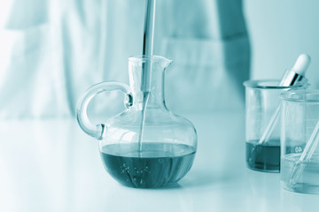 Beauty cosmetics sciences, Formulating and mixing skincare with herbal essence, Scientist pouring organic essential oil, Alternative healthy medicine.