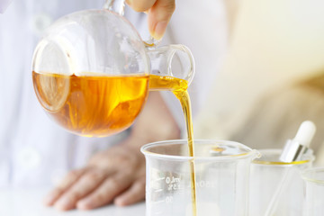 Beauty cosmetics sciences, Formulating and mixing skincare with herbal essence, Scientist pouring organic essential oil, Alternative healthy medicine.