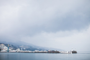 The promenade of Yalta. The port in the black sea. Cloudy weather on the black sea. The City Of Yalta- Crimea
