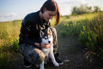 Beautiful young woman with little husky