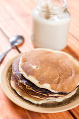 American pancakes on the plate with jar full of chocolate cream