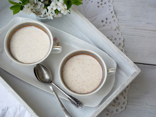White dessert Junket from milk and rennet extract with cinnamon in cups on light background. Jelly-like pudding made from sweet cottage cheese. Healthy food. Space for text