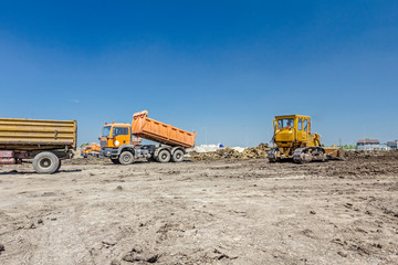 Dump truck is unloading soil