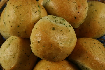 Homemade buns with garlic and dill on wooden table