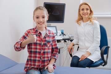 Joyful girl recommending excellent service of the clinic