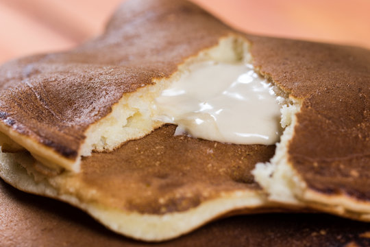 Closeup macro of stacked american pancakes stuffed with chocolate cream