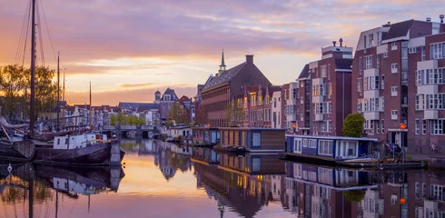 Fotobehang Netherlands Leiden Galgewater, View of sunrise in the morning with houses along side the Galgewater canal with boats resting in the water © Guido