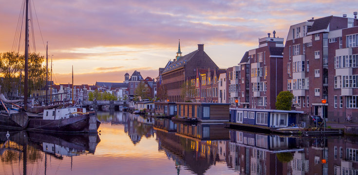 Netherlands Leiden Galgewater, View of sunrise in the morning with houses along side the Galgewater canal with boats resting in the water