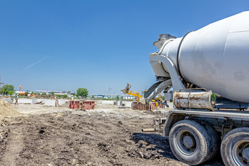 Back side view on concrete mixer, ready for pouring into transporter