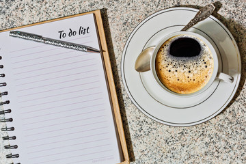 Notebook with to do list and a cup of coffee