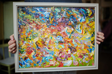 Human holding expressionism masterpiece in frame