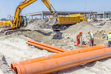 Placing new plastic pipes into the ground