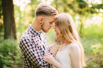 Beautiful Love story in the woods. Portrait of young stylish couple.