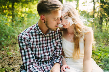 Fototapeta premium Beautiful Love story in the woods. Portrait of young stylish couple.