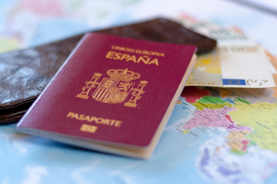 Spanish travel passport on the wallet with euro cash. Spanish citizenship.