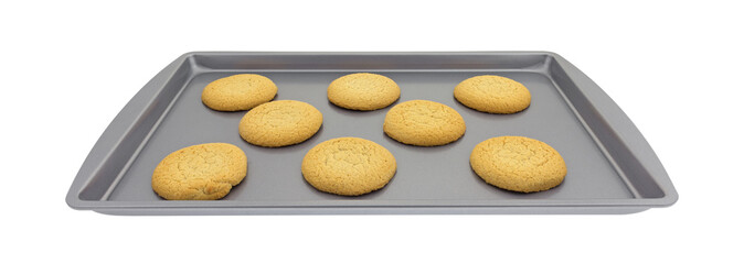 Several sugar cookies on a baking sheet isolated on a white background.