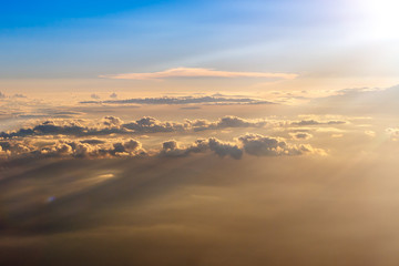 The colorful orange and blue soft sky above the clouds - airplane traveling in the summer