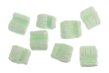 Several green packing peanuts isolated on a white background.