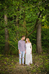 Beautiful Love story in the woods. Portrait of young stylish couple.