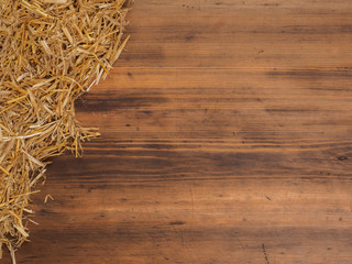 Rural eco background with and straw on the background of old wooden planks. The view from the top. Creative background for greeting cards, menu or advertising