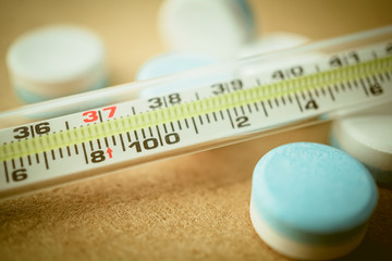 thermometer and pill medical concept
