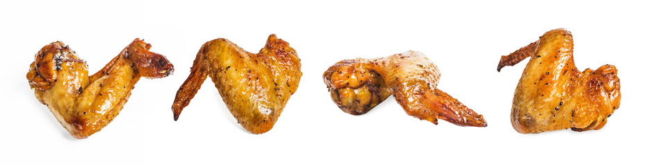 Baked chicken wings in pan on wooden table.