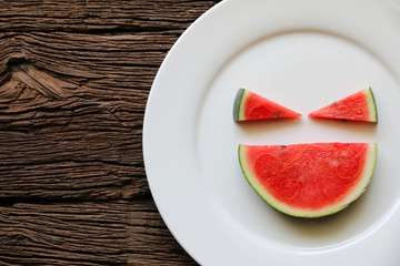 Watermelon smiles summer fruit in white plate