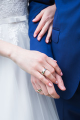 Hands of married couple with golden wedding rings