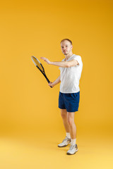 young tennis player plays tennis on yellow background
