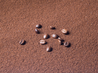 Grinded coffee background with scattered grains from top view