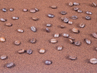 Grinded coffee background with scattered grains from top view