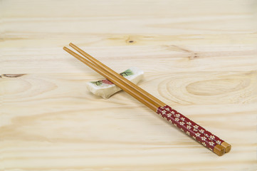 One set of Chopstick and holder on a wooden Pine table